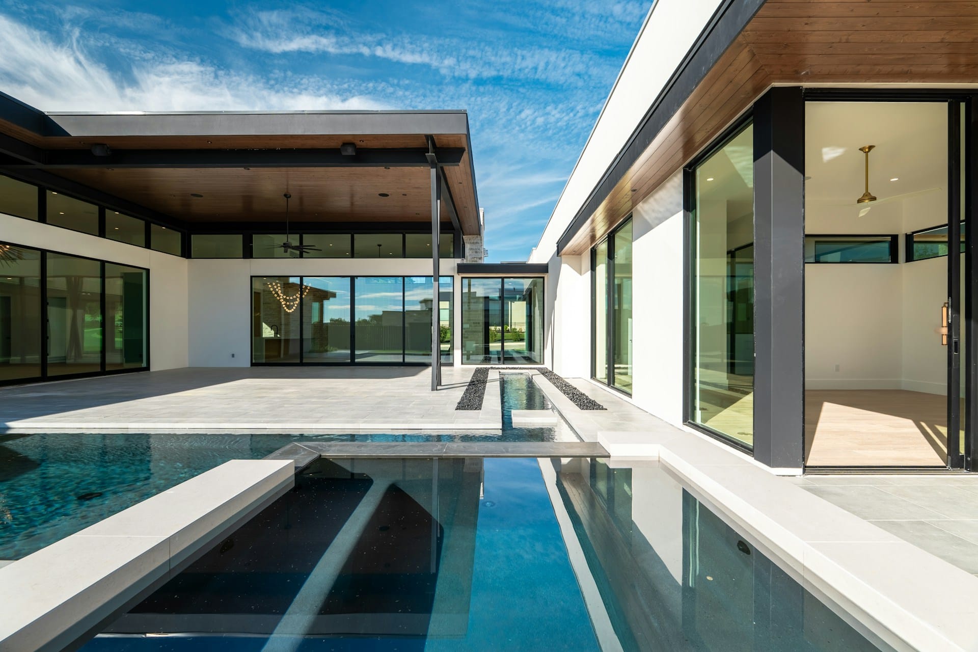 A contemporary Kingsbridge custom home with a reflecting pool